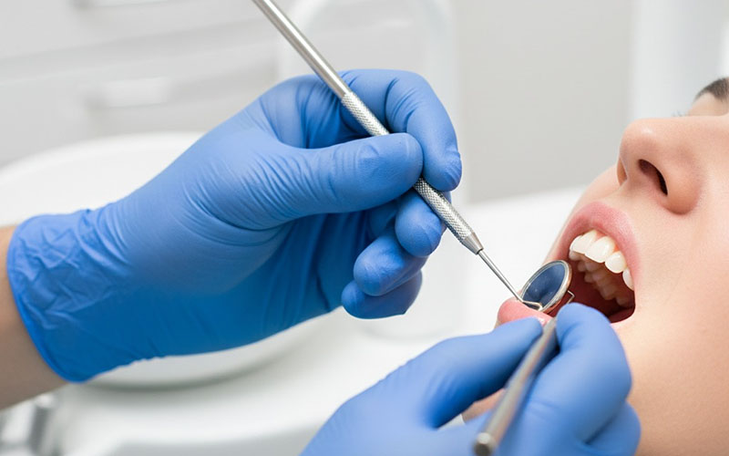 Dentist examining patient's teeth