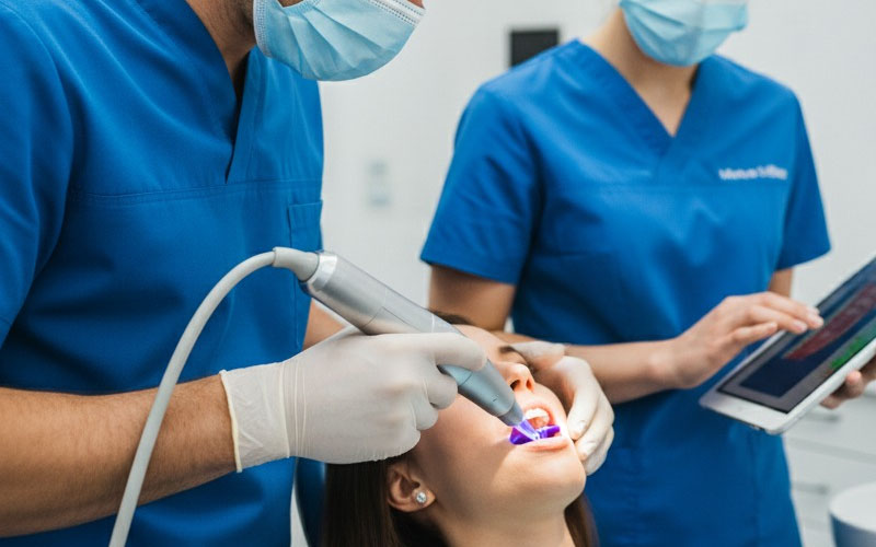 Dentist using complex modern dental technology